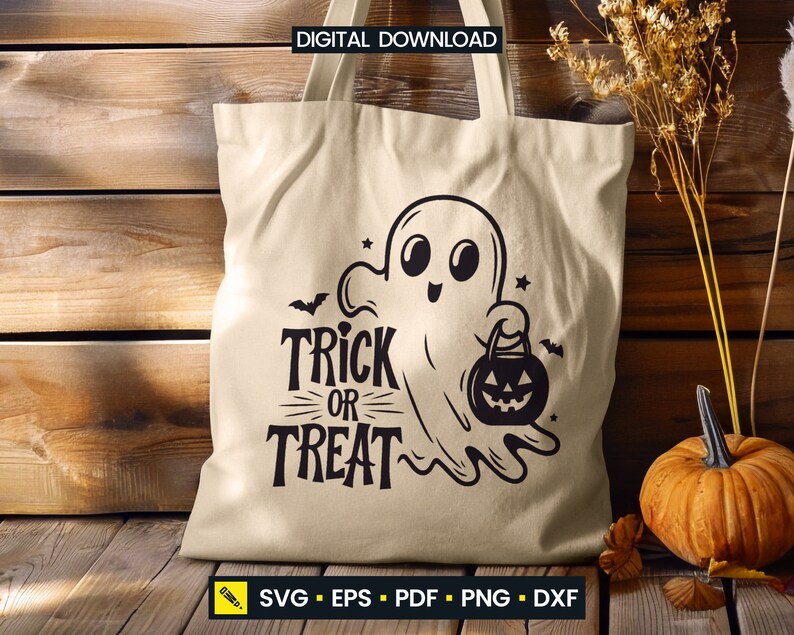 May include: Beige tote bag with a black Halloween-themed design. The design features a cartoon ghost holding a jack-o'-lantern and the words "Trick or Treat". The bag is made of a light-colored fabric and is suitable for carrying items.