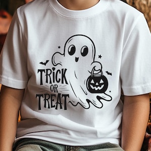 May include: White t-shirt featuring a black and white Halloween graphic. The design includes a friendly ghost holding a jack-o'-lantern, with the words "Trick or Treat" in a bold font. A bat and stars complete the festive design.