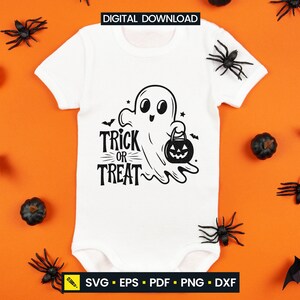 May include: White baby bodysuit with a black graphic of a friendly ghost holding a jack-o'-lantern and the words "Trick or Treat." The bodysuit is surrounded by Halloween decorations, including spiders, pumpkins, and bats.