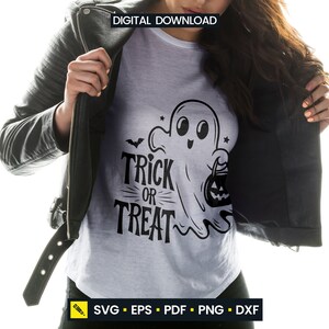 May include: A white t-shirt with a black graphic of a friendly ghost holding a jack-o'-lantern and the words "Trick or Treat". The shirt is worn under a black leather jacket. The words "Digital Download" are at the top.