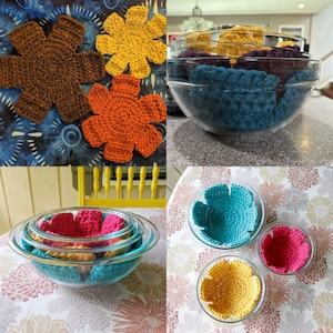 May include: A set of four crocheted flower bowl cozies in various colors, including brown, orange, yellow, and blue. The cozies are displayed on a table and in a glass bowl.