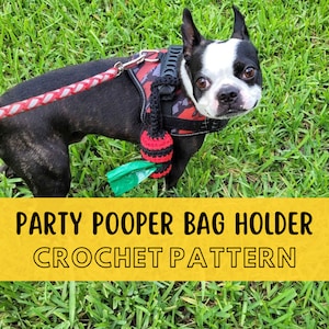 May include: A black and white dog wearing a red and black dog harness with a crocheted red and black poop bag holder attached. The dog is standing on green grass. The text "PARTY POOPER BAG HOLDER CROCHET PATTERN" is on a yellow banner.