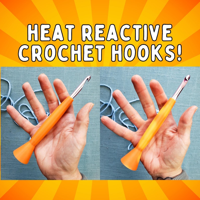 May include: Image of two orange heat reactive crochet hooks. The text "HEAT REACTIVE CROCHET HOOKS!" is displayed at the top of the image. The crochet hooks are held in hands, with blue yarn in the background.