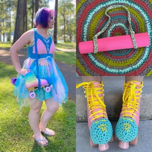 May include: A woman wearing a pink and blue crochet top and a matching skirt. She is holding a pair of pink roller skates with blue wheels. The skates have a crocheted flower on each wheel. The woman is standing in front of a green grassy area.