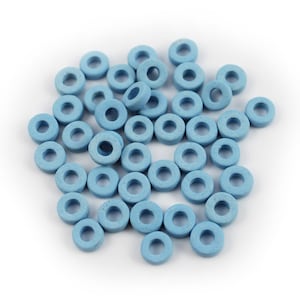 May include: A pile of light blue ceramic rings, scattered on a white background.