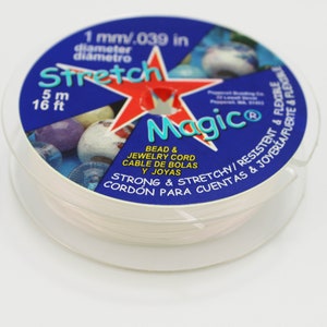 May include: A spool of Stretch Magic bead and jewellery cord. The clear, elastic cord is 1 mm in diameter and 5 m (16 ft) long. The blue label features a red star and text that reads "Strong & Stretchy".