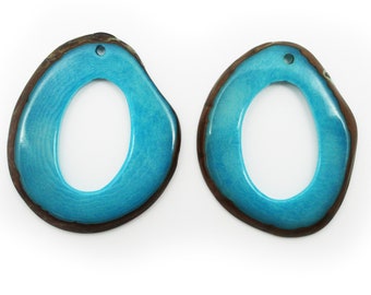 May include: Two turquoise blue, open-oval shaped earrings with a dark brown border. The earrings have a glossy finish and a small hole at the top for hanging. The earrings are displayed against a white background.