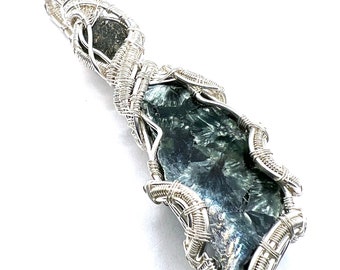 Seraphinite gemstone pendant with Moldavite wire wrapped in fine silver. Infinite Possibilities For Healing