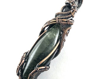 Green Rutile in Quartz gemstone pendant with Iolite wire wrapped in copper. Linking Mind & Heart