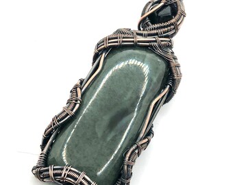 Nephrite Jade gemstone pendant with Black Tourmaline wire wrapped in copper. Stimulating The Protective Energies Of The Heart