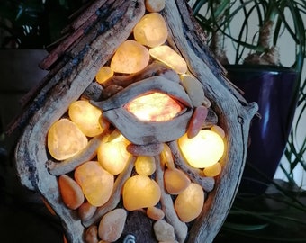 Unique driftwood table lamp in the shape of a fairy house, with yellow quartz pebbles