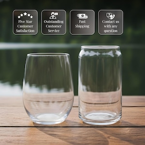 two empty wine glasses placed side by side on a wooden surface, with a blurred background.