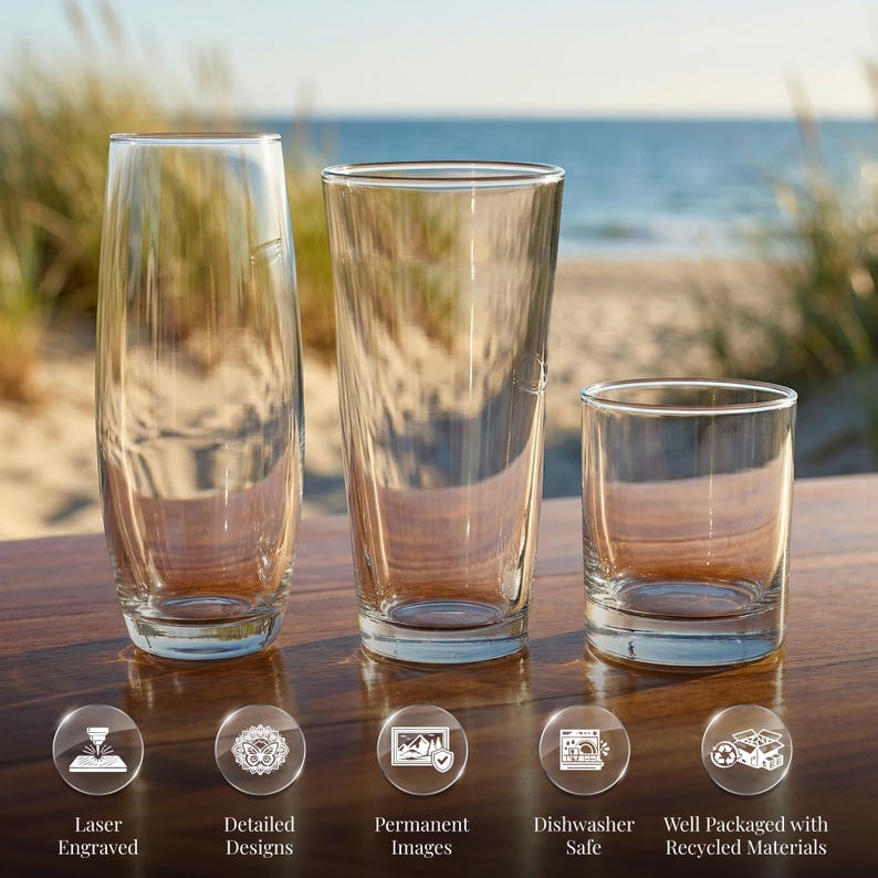 Three different-sized glass cups are displayed on a wooden surface, with a beach and ocean in the background.