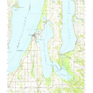 May include: A vintage topographic map of Elk Rapids, Michigan, showing the area around Elk Rapids, Torch Lake, and Grand Traverse Bay. The map includes details such as roads, rivers, lakes, and elevation contours. The map is printed on a light blue background with brown lines and text.