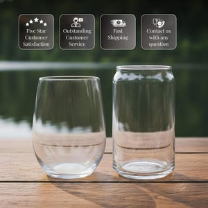 two empty wine glasses placed side by side on a wooden surface, with a blurred background.