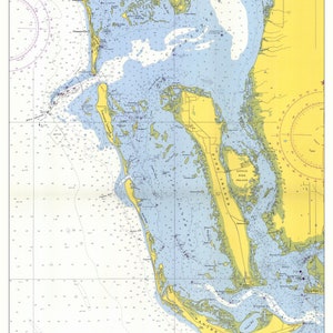 May include: A nautical chart of the waterways around Sanibel Island, Florida. The chart shows the coastline, inlets, and channels. The chart is printed in blue, yellow, and black.