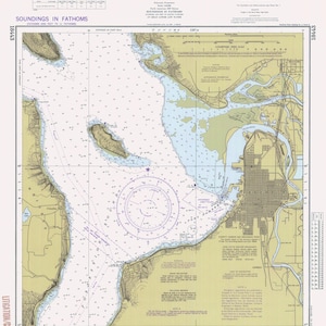 May include: A nautical chart of the approaches to Everett, Washington. The chart shows the shoreline, waterways, and depths of the water in fathoms. The chart also includes various navigational aids, such as buoys, lights, and landmarks. The chart is titled "Approaches to Everett" and is dated 18443.