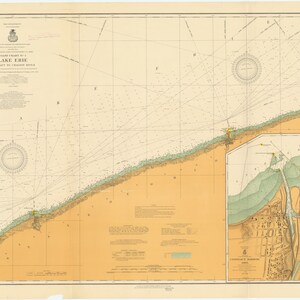 May include: A vintage nautical chart of Lake Erie, showing the shoreline and surrounding waters. The chart includes depth soundings, navigational aids, and other important information for mariners. The chart is printed on a cream-colored paper with a light blue tint for the water.