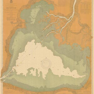 May include: A vintage map of Lake Saint Clair, showing the shoreline, depth soundings, and navigational aids. The map is printed on a beige background with green and brown markings.