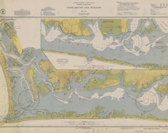 May include: A vintage nautical chart of Core Sound and Straits in North Carolina. The chart is printed in black, blue, green, and yellow ink on a white background. It shows the coastline, waterways, and islands of the area. The chart is titled "Core Sound and Straits" and includes a compass rose and a scale bar.