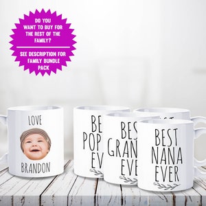 May include: White ceramic mugs with black text and a baby's photo. One mug says "LOVE BRANDON", others say "BEST POP EVER", "BEST GRAN EVER", and "BEST NANA EVER". A pink starburst graphic at the top says "DO YOU WANT TO BUY FOR THE REST OF THE FAMILY?"