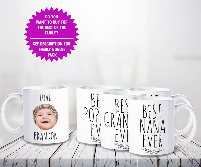 May include: White ceramic mugs with black text and a baby's photo. One mug says "LOVE BRANDON", others say "BEST POP EVER", "BEST GRAN EVER", and "BEST NANA EVER". A pink starburst graphic at the top says "DO YOU WANT TO BUY FOR THE REST OF THE FAMILY?"