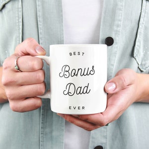 May include: White ceramic mug with black text that reads "Best Bonus Dad Ever".