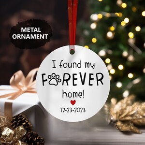a white ornament with a red heart on it
