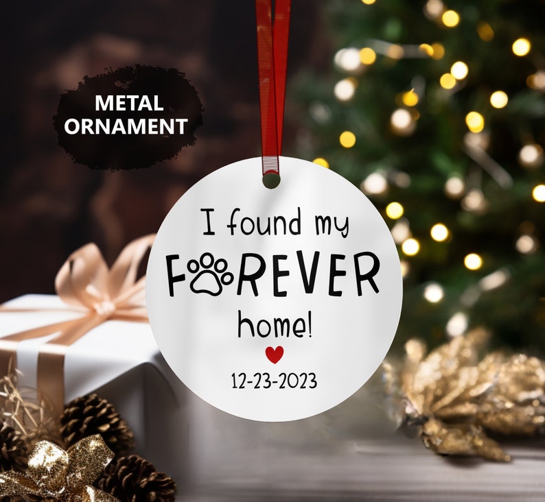 a white ornament with a red heart on it