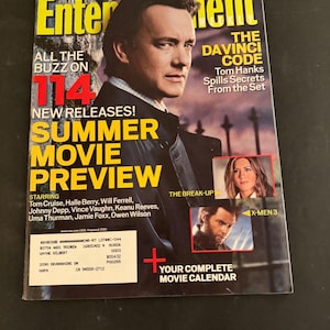 May include: An Entertainment Weekly magazine cover from April 28/May 5, 2006, featuring Tom Hanks on the cover. The text reads Summer Movie Preview, The Da Vinci Code, and lists various actors. Smaller inset images show scenes from The Break-Up and X-Men 3.