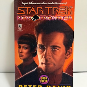 May include: A paperback book titled "STAR TREK NEW FRONTIER BOOK THREE" by Peter David. The cover features a portrait of a man and a woman, with the Star Trek logo in orange and the book title in purple.