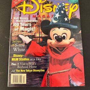 May include: A Disney Magazine cover featuring Mickey Mouse in a sorcerer's hat and red robe. The magazine cover has the Disney logo and text that reads "Walt Disney World Celebrates 100 Years of Magic!" and "Monsters, Inc. A First Look."