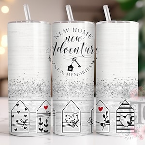 May include: Three white stainless steel tumblers with black and silver glitter accents. The tumblers feature a black and white graphic of houses with hearts and the text "New Home New Adventure New Memories".