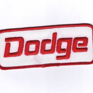 May include: Red embroidered patch with a white background and the word "Dodge" in red lettering.