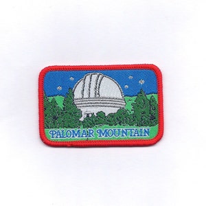 May include: A red, blue, and green embroidered patch with a white observatory dome and the text "Palomar Mountain".