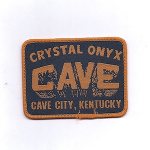 May include: A brown and orange embroidered patch with the text "Crystal Onyx Cave" and "Cave City, Kentucky".