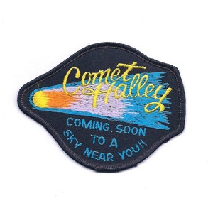 May include: A black embroidered patch with a yellow comet and the text "Comet Halley Coming Soon To A Sky Near You!"