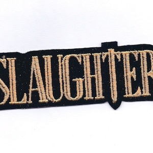 May include: Black embroidered patch with the word "SLAUGHTER" in gold thread.