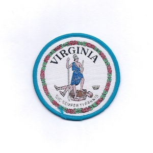 May include: A blue and white embroidered patch with the state seal of Virginia. The seal features a woman standing on a man, holding a spear. The text "SIC SEMPER TYRANNIS" and "VIRGINIA" are visible on the patch.