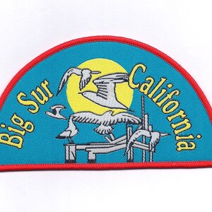 May include: A blue and red half-circle patch with the text "Big Sur California" and a yellow sun with four white seagulls flying around it.