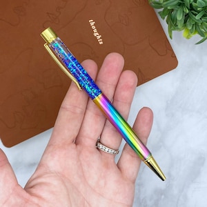 Rainbow metal ballpoint pen with floating glitter and gold hardware