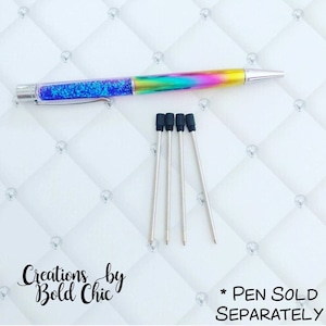 May include: Five black and silver pen refills with black rubber tips. The pen refills are on a white background with a diamond pattern. *PEN SOLD SEPARATELY* is written in black text on the bottom right corner of the image.