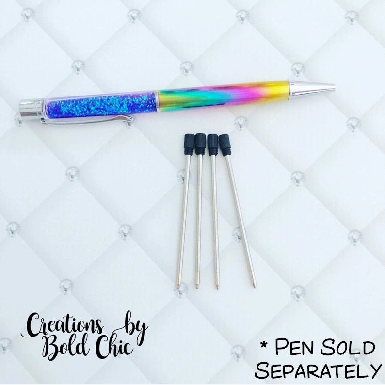May include: Five black and silver pen refills with black rubber tips. The pen refills are on a white background with a diamond pattern. *PEN SOLD SEPARATELY* is written in black text on the bottom right corner of the image.