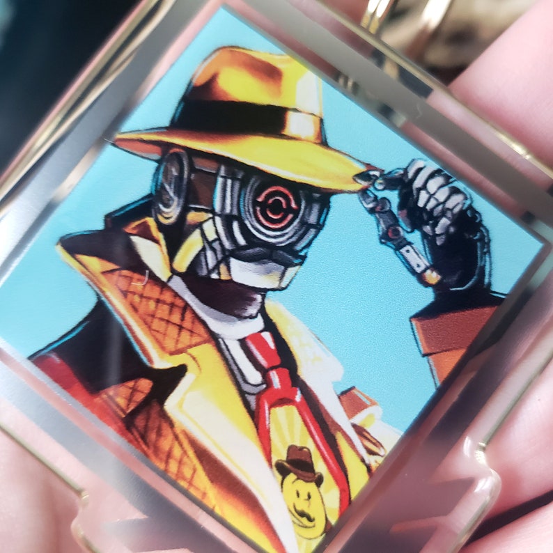 May include: A yellow and black robot wearing a yellow fedora and a brown trench coat with a red tie. The robot has a large, round, black eye with a red circle in the center. The robot is holding a magnifying glass in its right hand.