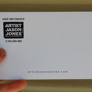 Pode incluir: Cart&atilde;o branco com texto preto que diz "Altered Thrift Store Art By Artist Jason Jones" e "artistijasonjones.com". Copyright 2014 Jason Jones.