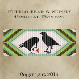 May include: A beaded pattern featuring two black birds facing each other, with a red and white floral design between them. The design is framed by green, blue, and brown stripes. Text at the top reads "PUEBLO BEAD & SUPPLY ORIGINAL PATTERN". Copyright 2014.