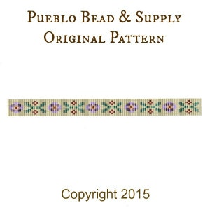 May include: A beaded pattern with purple flowers, green leaves, and red and brown accents on a beige background. The text "Pueblo Bead & Supply Original Pattern" and "Copyright 2015" is included.