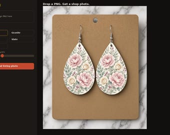 May include: A pair of teardrop-shaped earrings featuring a floral pattern with pink and cream-coloured peonies and green foliage. The earrings are attached to a rectangular brown display card with a single hole at the top for hanging purposes.