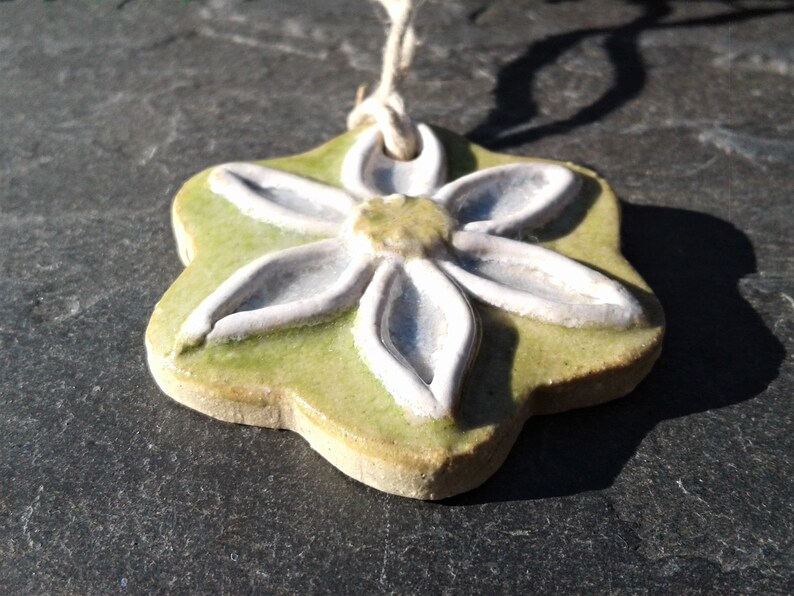 ORNAMENT White and Blue Petals with Yellow Center Ceramic Flower with Lime Green Background