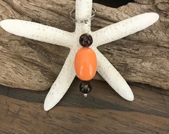 ORANGE Key Chain/charm. Large Orange  center bead. 2 smaller brown marble beads. Purse charm. Beads of Hope.  Made in Kenya.